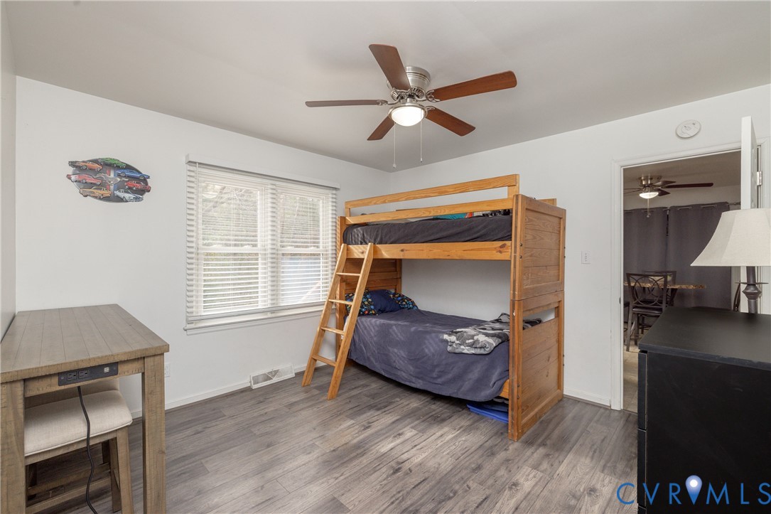16104 Sandwave Road Chester, VA 23831 - Photo 19 of 24 a bedroom with a bed and wooden floor