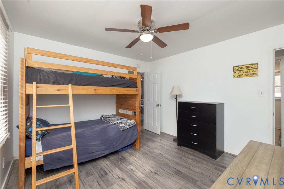 16104 Sandwave Road Chester, VA 23831 - Photo 20 of 24 a bedroom with a bed and a ceiling fan