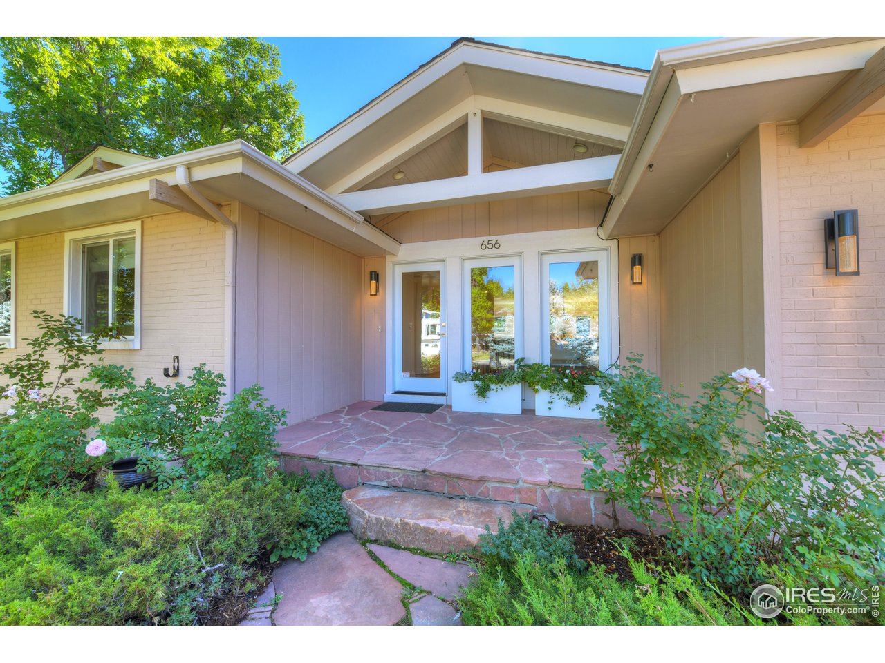 656 Furman Way Boulder, CO 80305 - Photo 1 of 6 a view of a house with brick walls and a yard