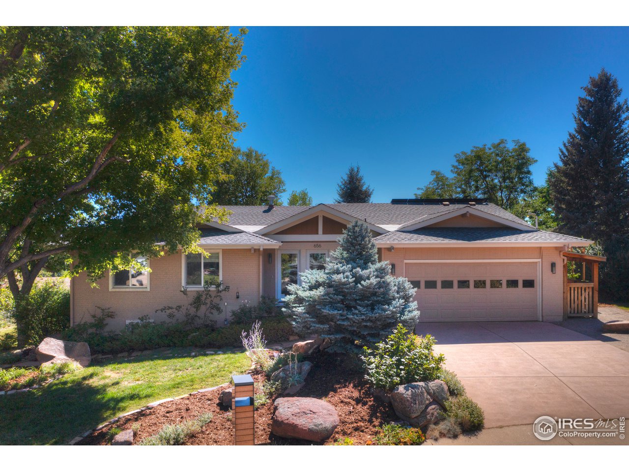 656 Furman Way Boulder, CO 80305 - Photo 6 of 6 a front view of a house with a garden