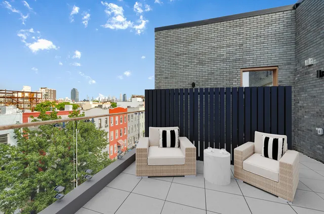 a balcony with furniture and a potted plant
