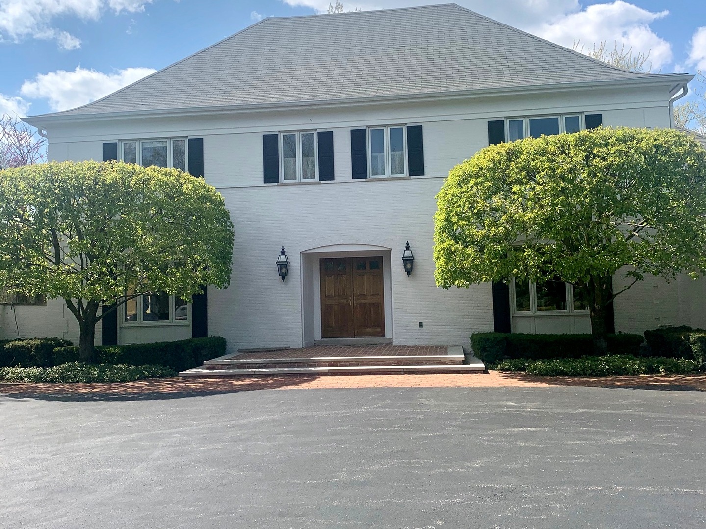 1780 Sunset Ridge Road Northbrook, IL 60062 - Photo 1 of 11 a front view of a house with a yard and garage