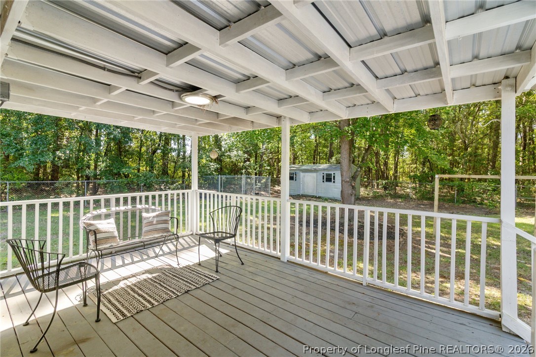 6568 Sandy Creek Road Stedman, NC 28391 - Photo 24 of 34 a view of a balcony with wooden floor