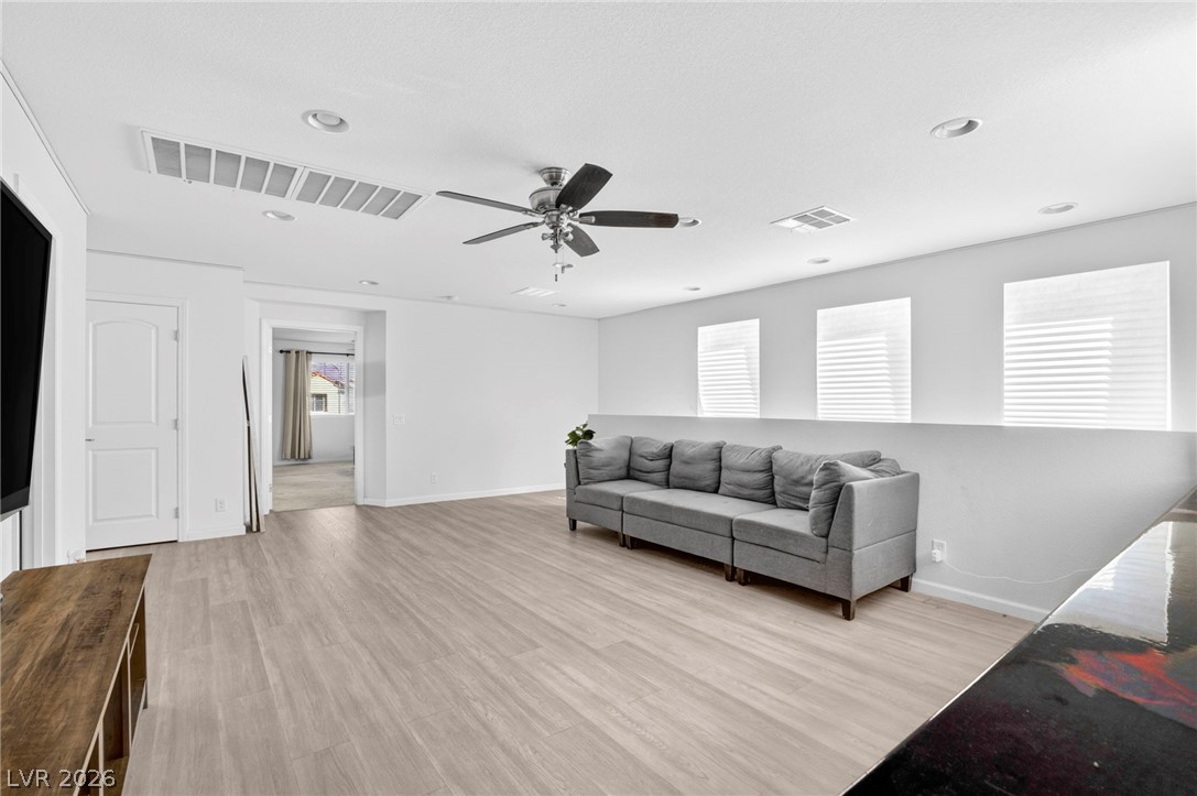 6281 Angora Peak Lane Las Vegas, NV 89115 - Photo 24 of 34 A well-lit sitting room boasts recessed lighting and durable wood flooring.