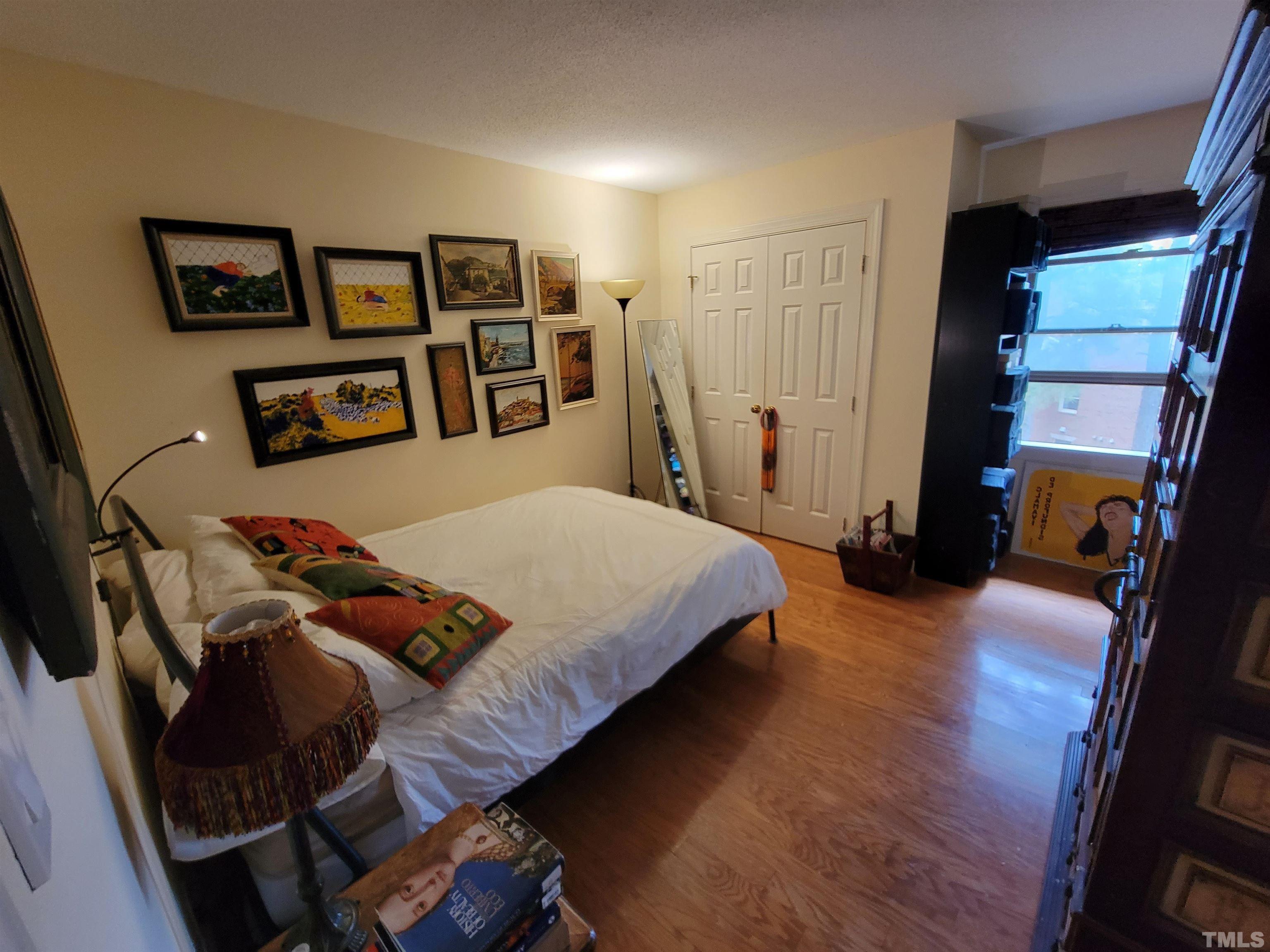 3601 Helix Court, Unit 302 Raleigh, NC 27606 - Photo 12 of 21 a bedroom with a bed and a large mirror in a dresser
