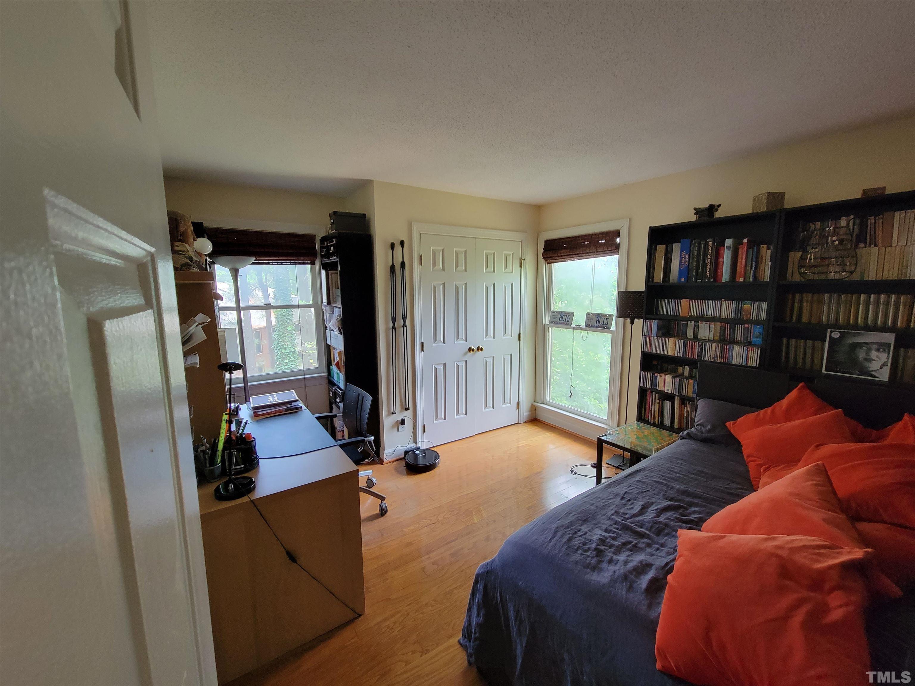 3601 Helix Court, Unit 302 Raleigh, NC 27606 - Photo 14 of 21 a bedroom with a bed and a book shelf