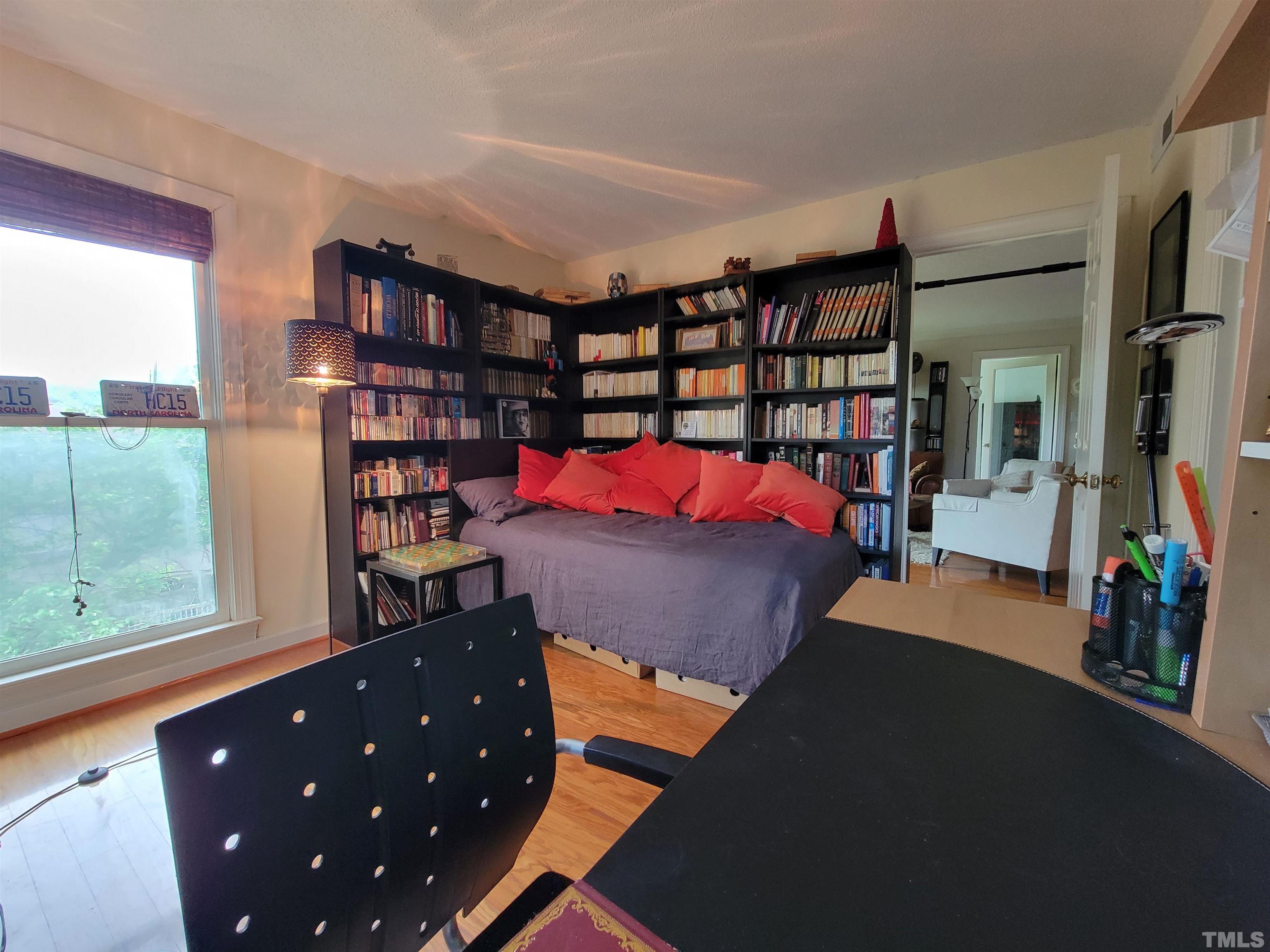 3601 Helix Court, Unit 302 Raleigh, NC 27606 - Photo 15 of 21 a bed room with a bed and a book shelf