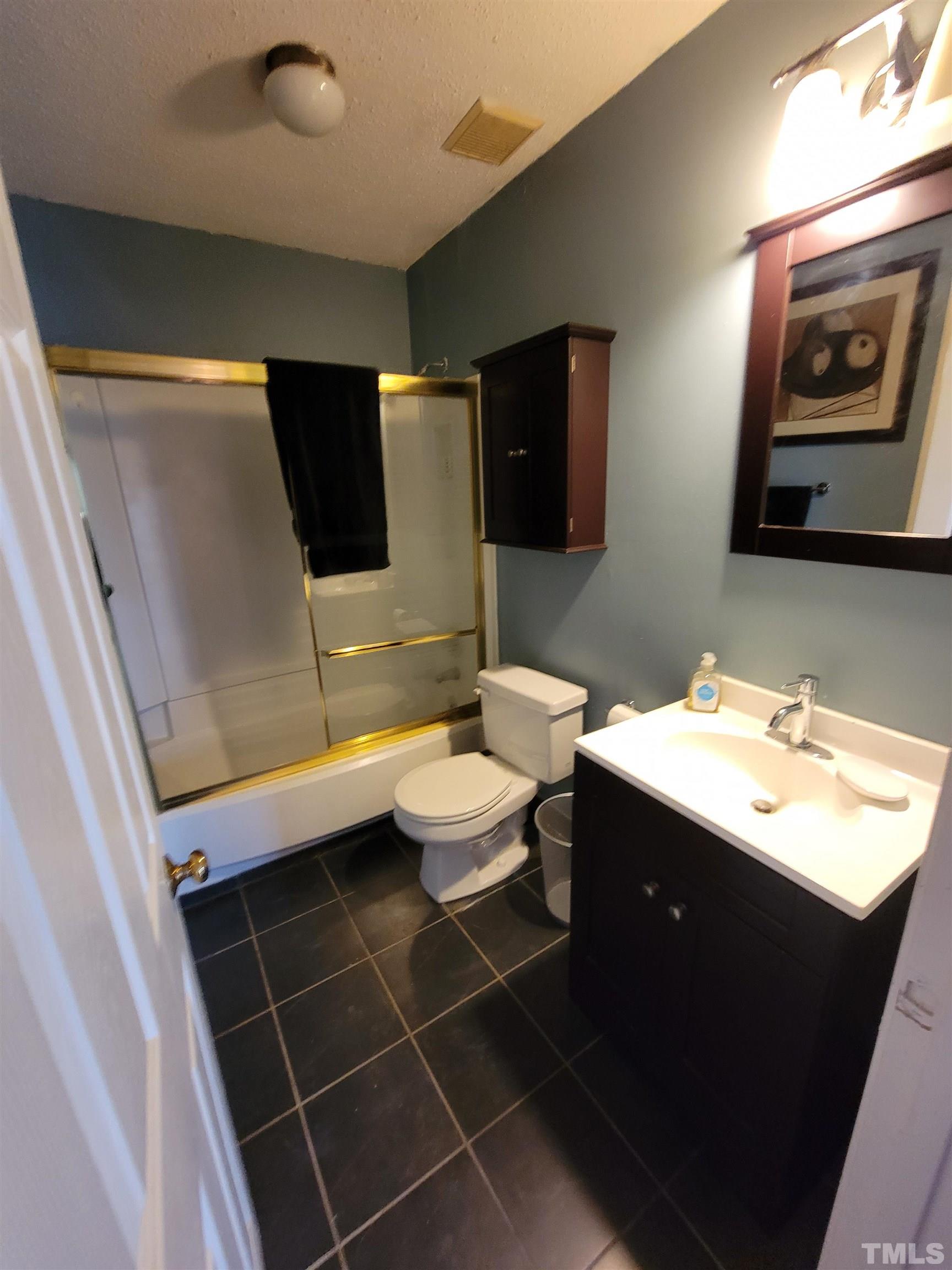 3601 Helix Court, Unit 302 Raleigh, NC 27606 - Photo 17 of 21 a bathroom with a sink toilet and mirror