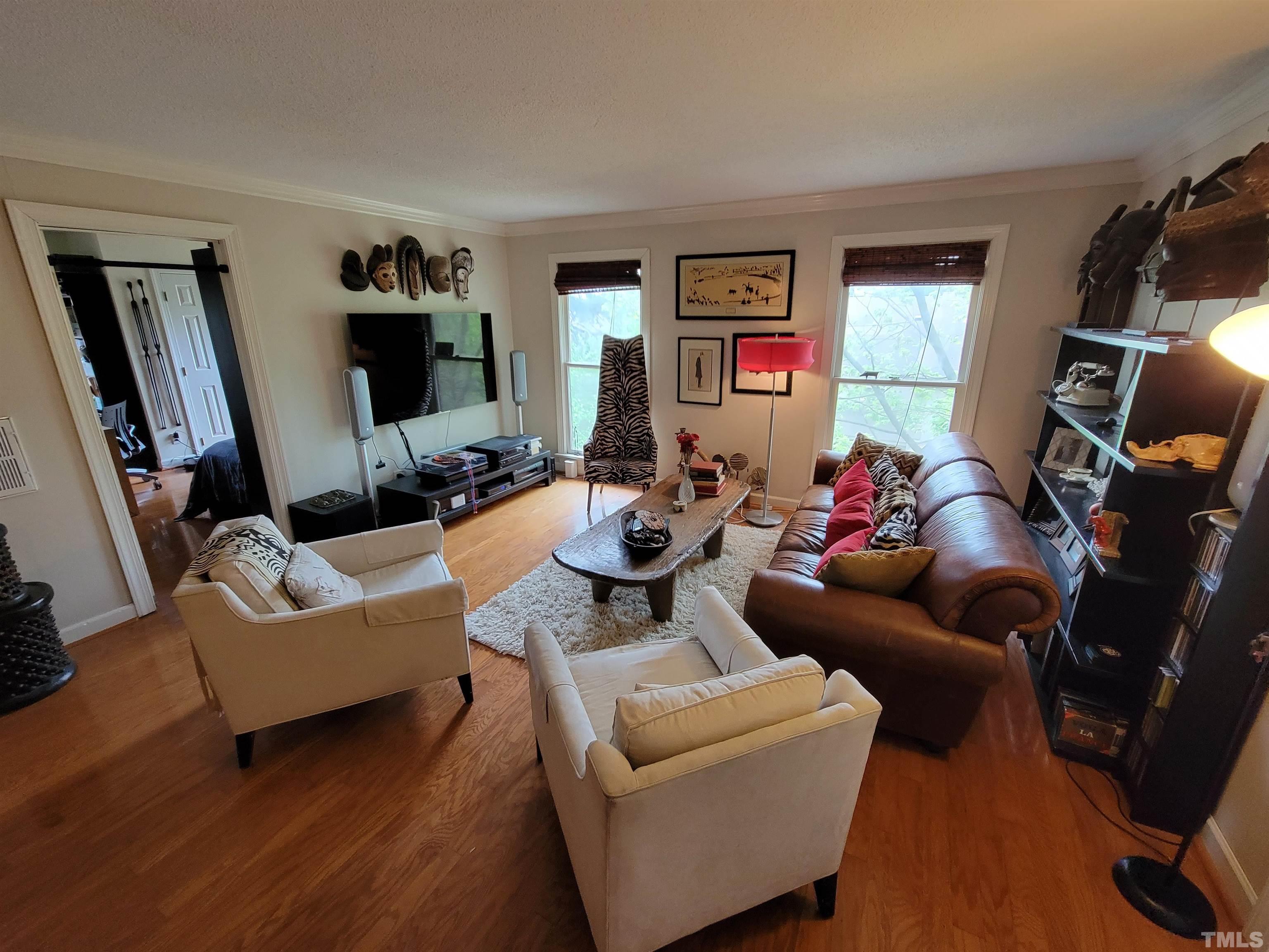3601 Helix Court, Unit 302 Raleigh, NC 27606 - Photo 3 of 21 a living room with furniture and a flat screen tv