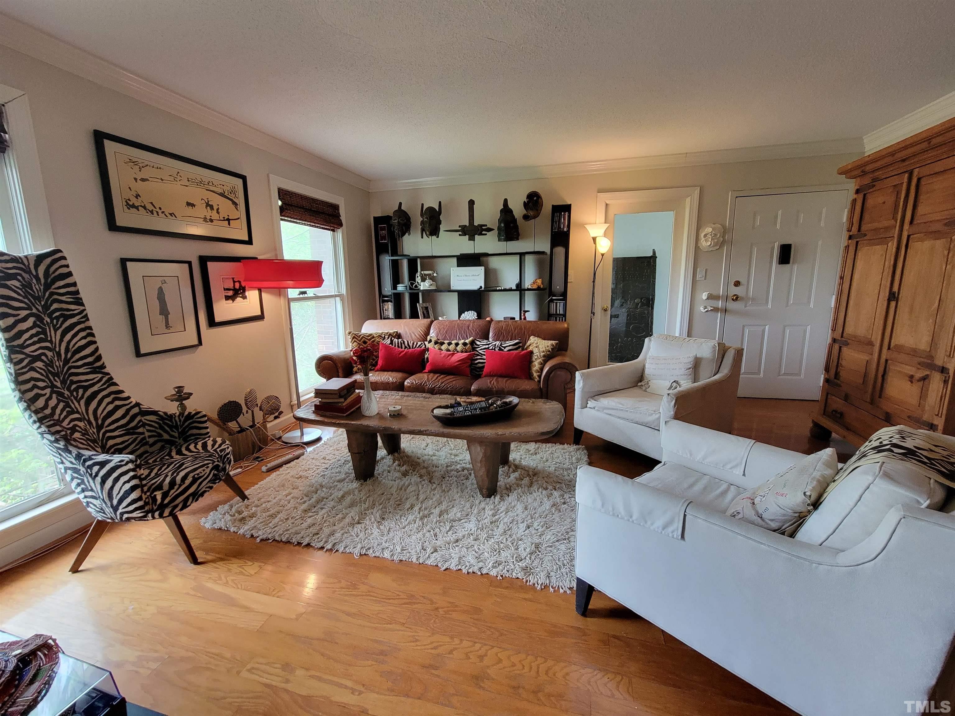 3601 Helix Court, Unit 302 Raleigh, NC 27606 - Photo 4 of 21 a living room with furniture and a flat screen tv