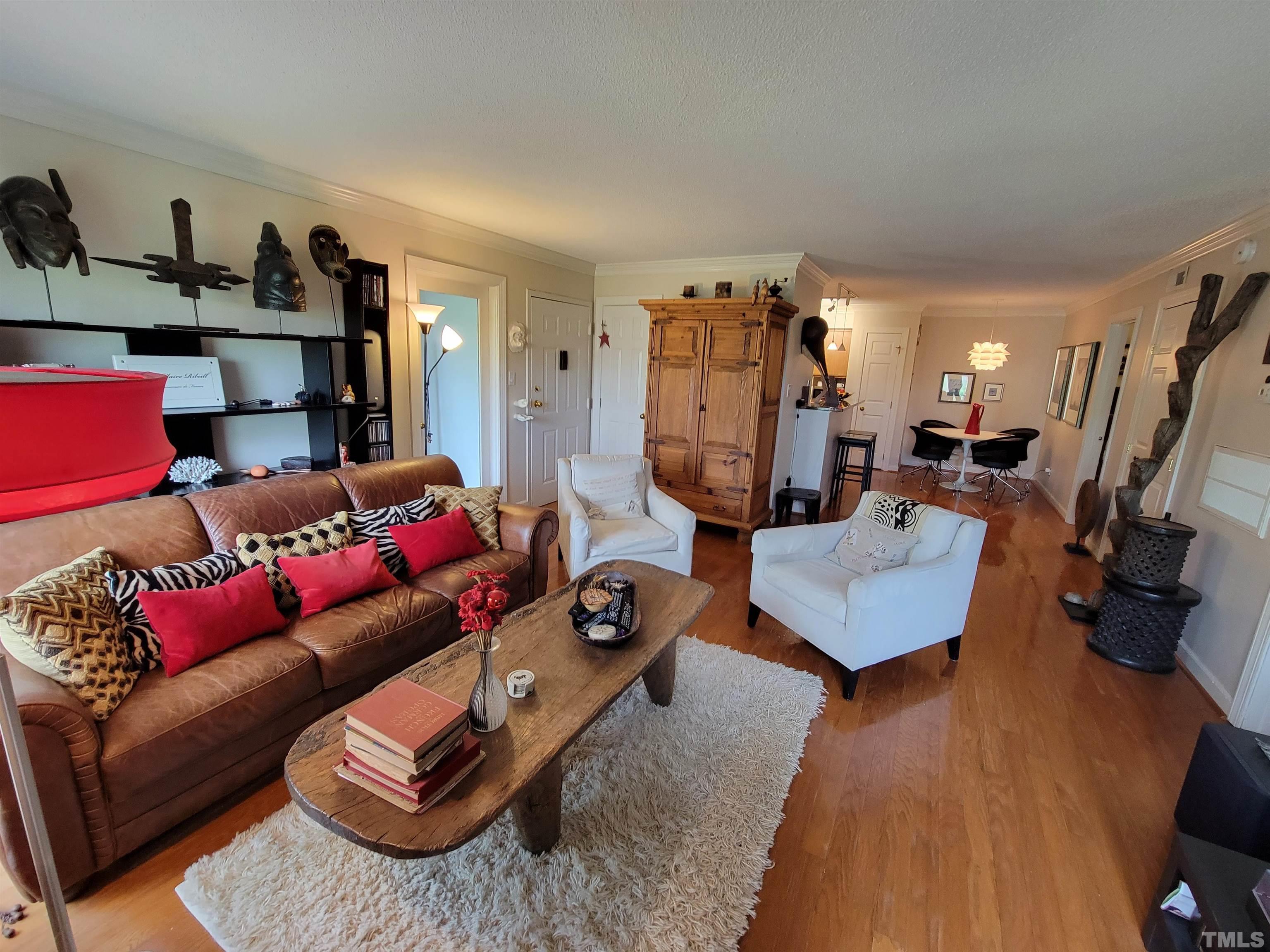 3601 Helix Court, Unit 302 Raleigh, NC 27606 - Photo 5 of 21 a living room with furniture and a flat screen tv