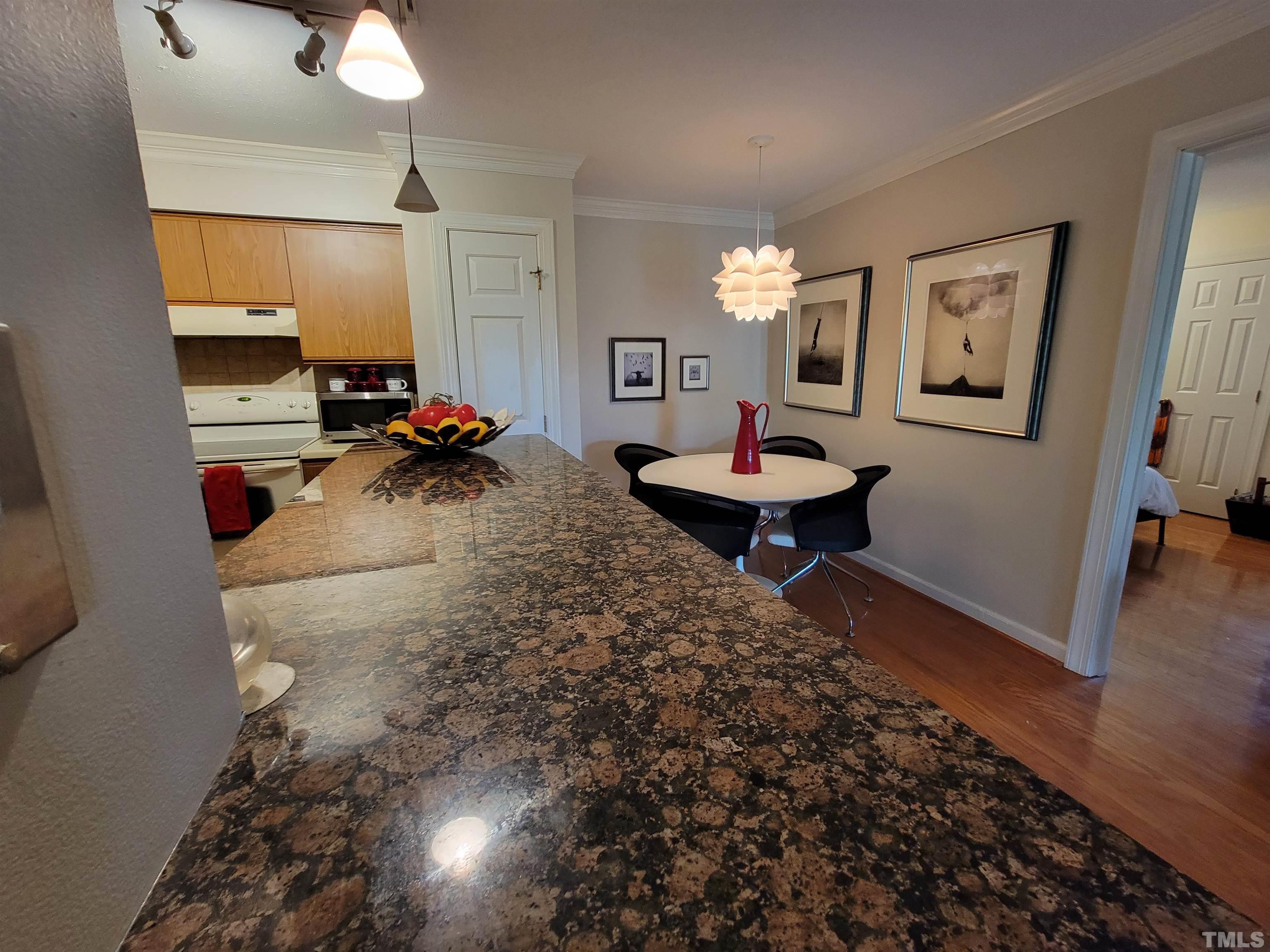 3601 Helix Court, Unit 302 Raleigh, NC 27606 - Photo 6 of 21 a living room with furniture and a wooden floor