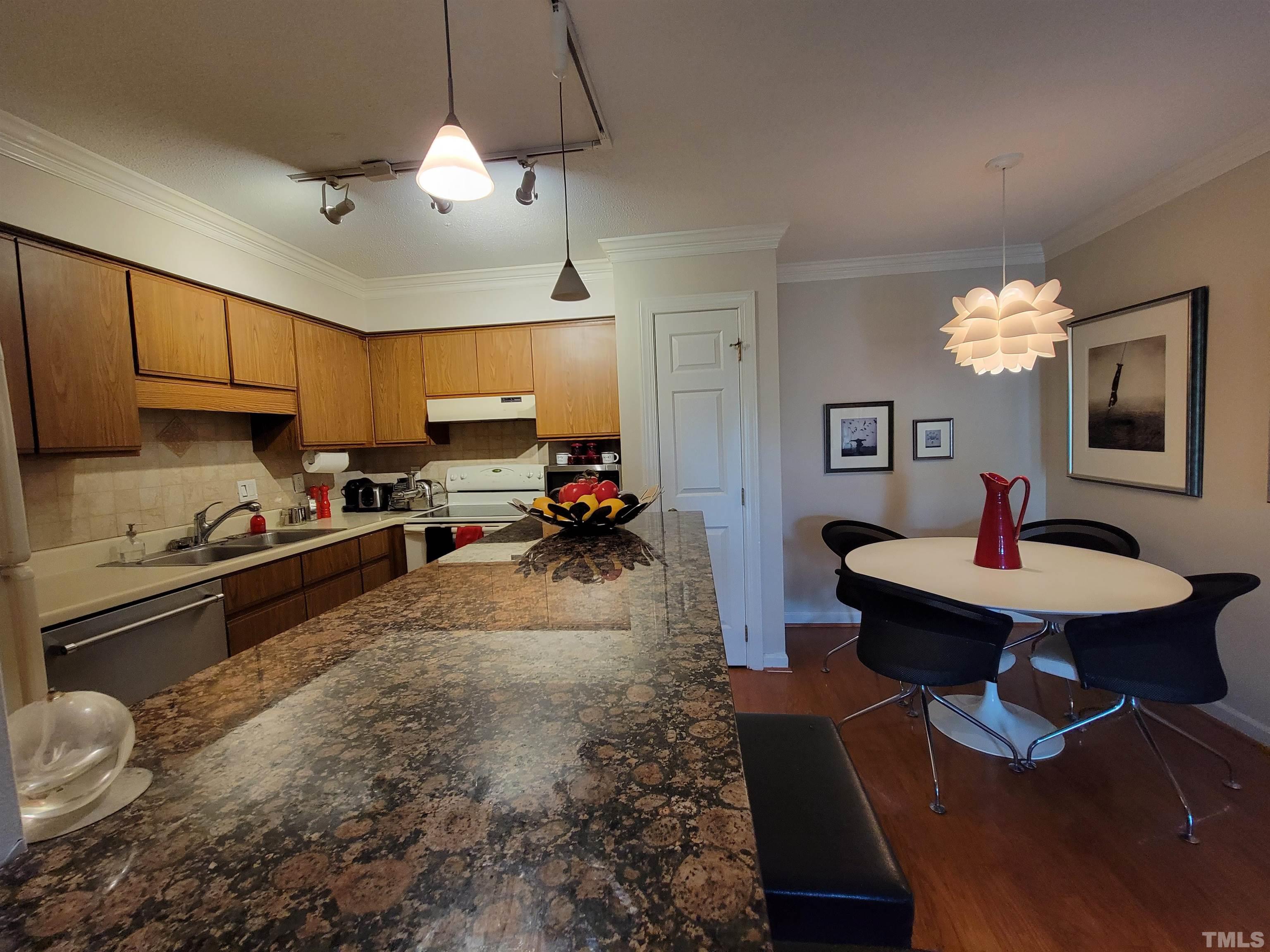3601 Helix Court, Unit 302 Raleigh, NC 27606 - Photo 7 of 21 a kitchen with sink refrigerator and microwave