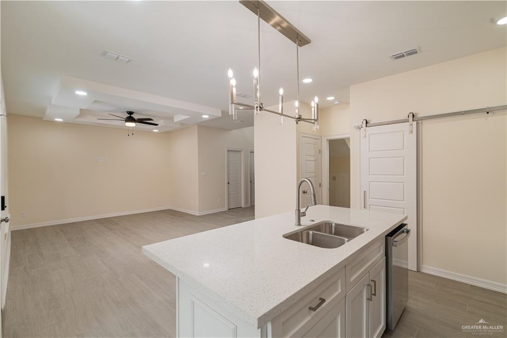 5406 North Crown Point Pharr, TX 78577 - Photo 8 of 15 a kitchen with a sink a counter space and a refrigerator