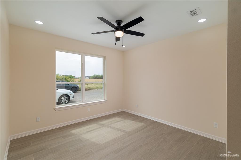 5406 North Crown Point Pharr, TX 78577 - Photo 10 of 15 an empty room with window and ceiling fan