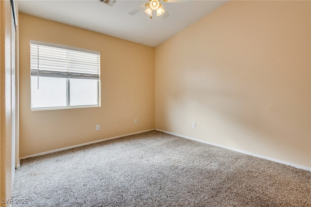 6354 Rusticated Stone Avenue, Unit 101 Henderson, NV 89011 - Photo 16 of 21 Spare room featuring carpet floors and ceiling fan