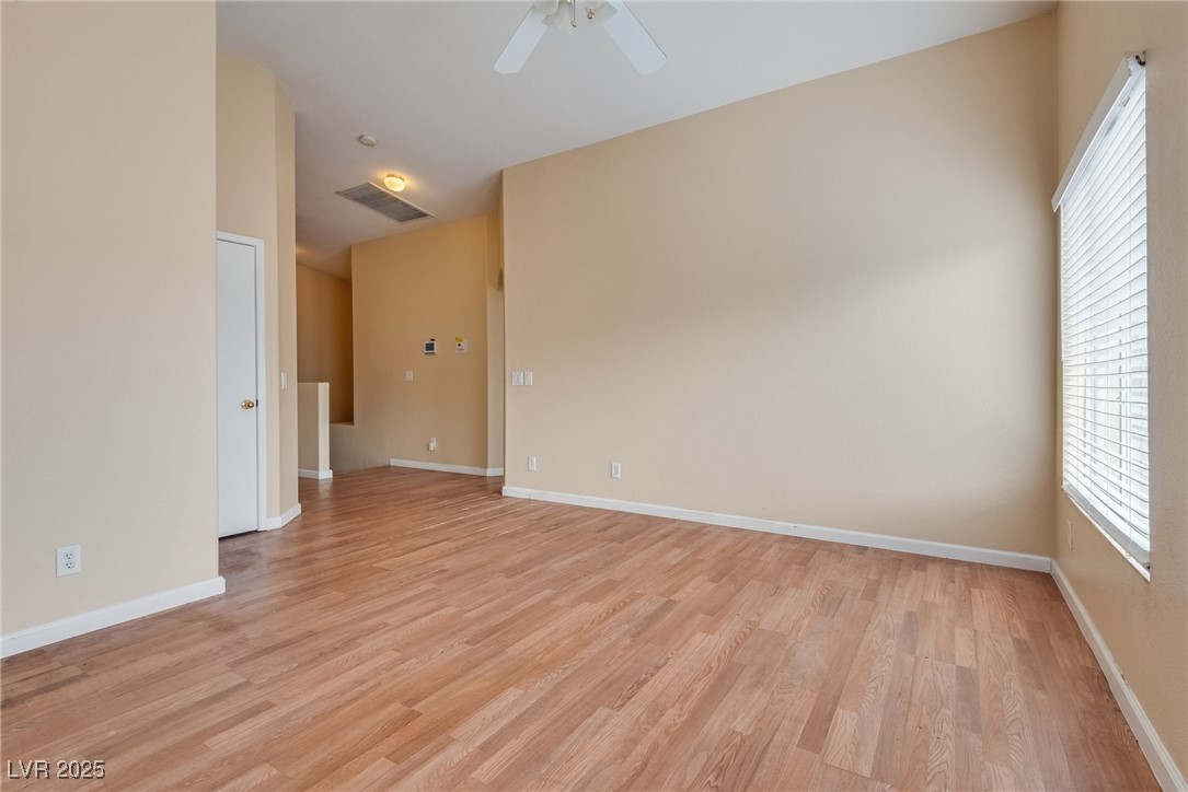 6354 Rusticated Stone Avenue, Unit 101 Henderson, NV 89011 - Photo 5 of 21 Empty room with light wood-style floors and ceiling fan