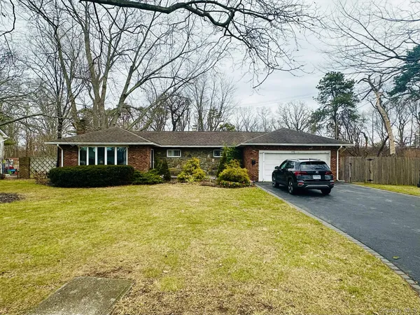 a view of a house with truck parked on the road