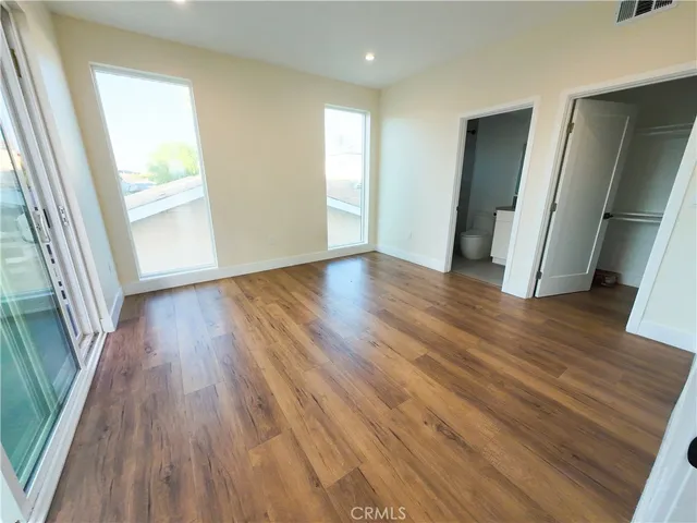 a view of a room with wooden floor and window