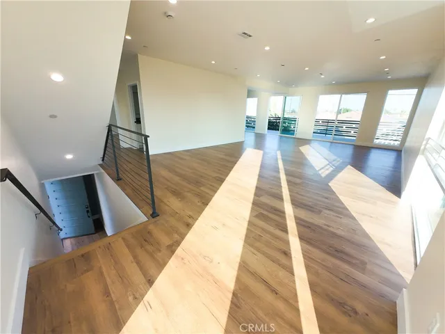 a view of a living room with wooden floor