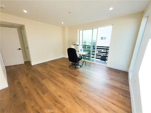 a view of a room with wooden floor and windows