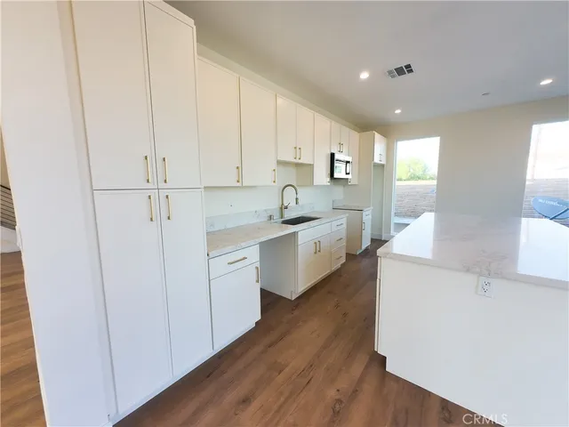 a view of a kitchen with electric appliances