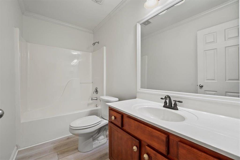 1218 Morgans Run Monroe, GA 30656 - Photo 22 of 39 a bathroom with a sink a toilet and shower