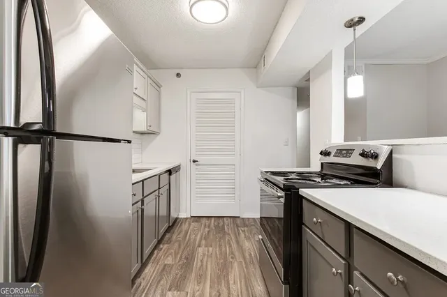 a kitchen with a stove a refrigerator and a stove