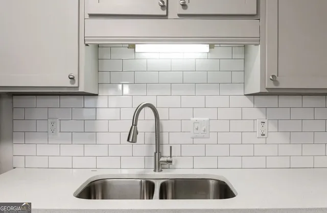 a bathroom with a sink and cabinets