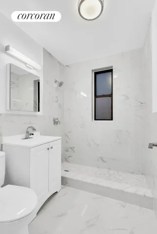 a bathroom with a toilet a sink a mirror and a bathtub