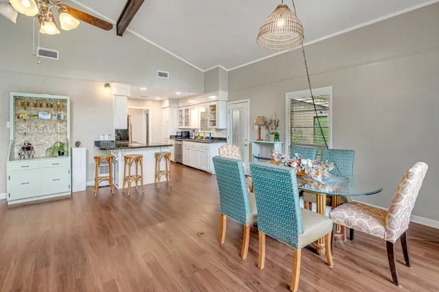 a dining room with furniture and wooden floor
