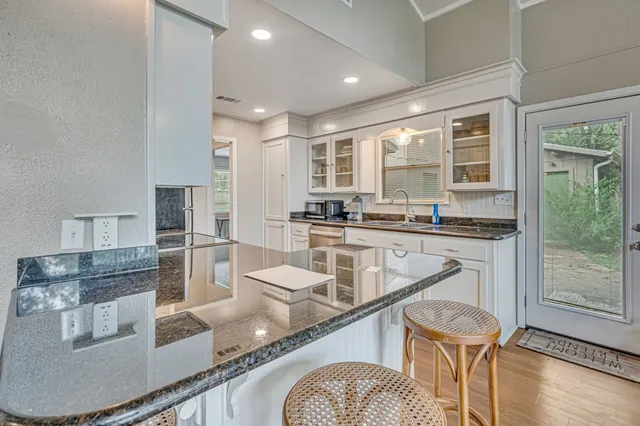 a kitchen with stainless steel appliances granite countertop a sink and cabinets