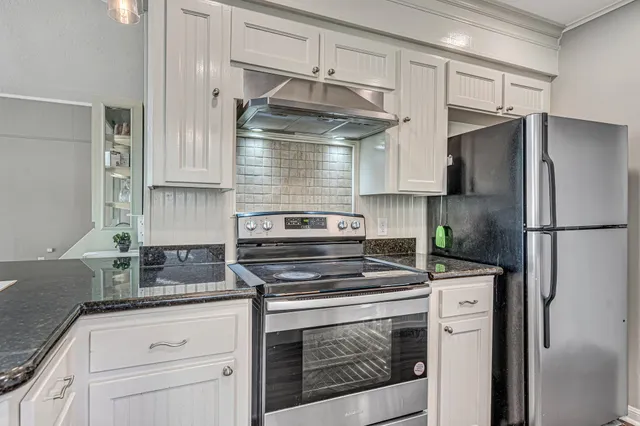 a kitchen with cabinets and stainless steel appliances