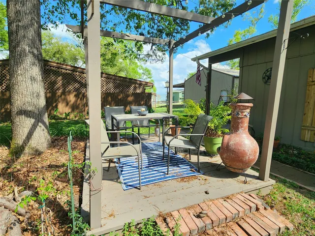 a view of a porch with chairs and potted plants