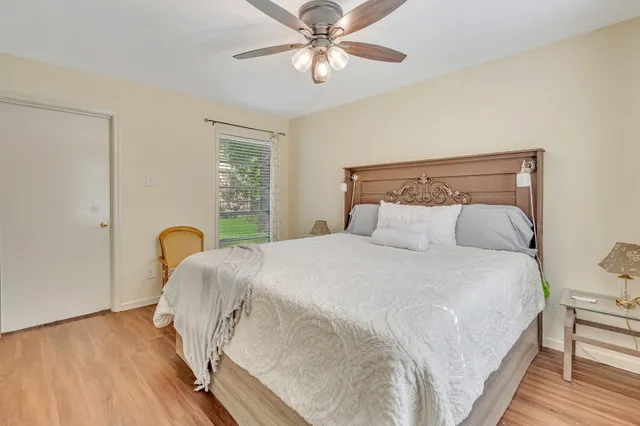 a bedroom with a bed and a chandelier