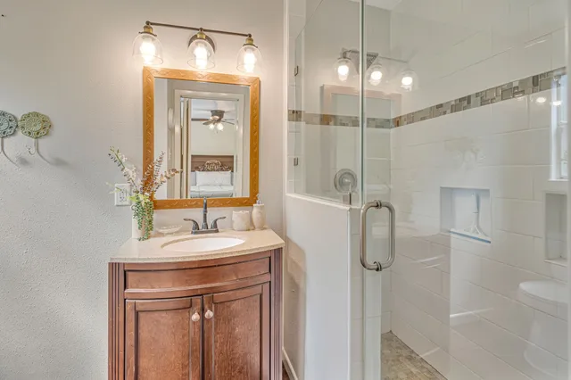 a bathroom with a sink a toilet and shower