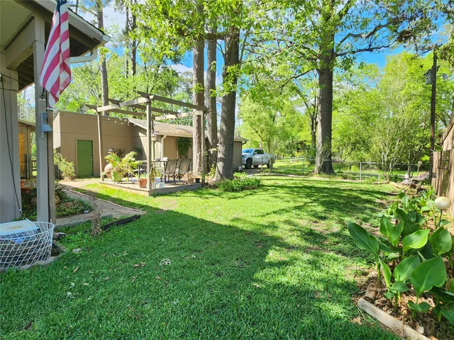 a view of a house with a yard and sitting area