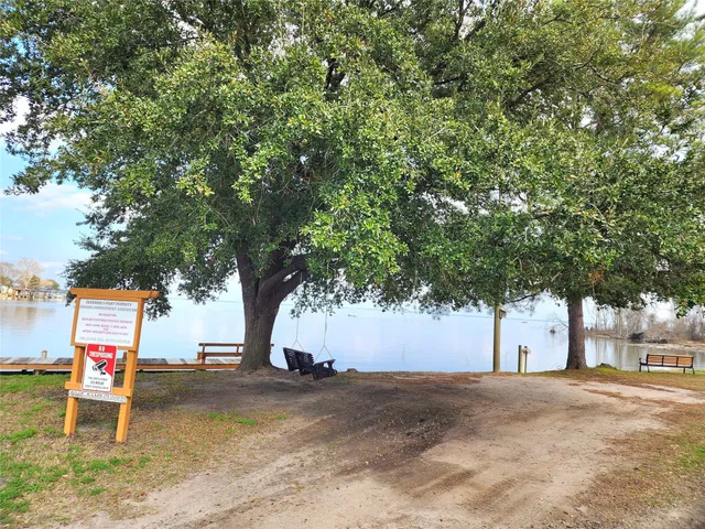 a bed room with a bed and three large window