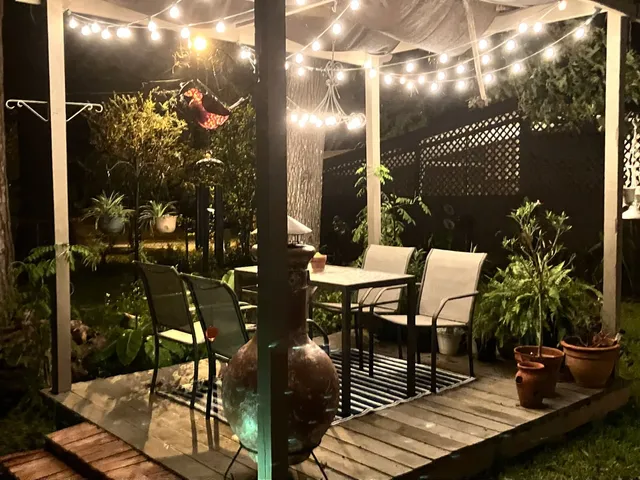 a view of a porch with chairs and potted plants