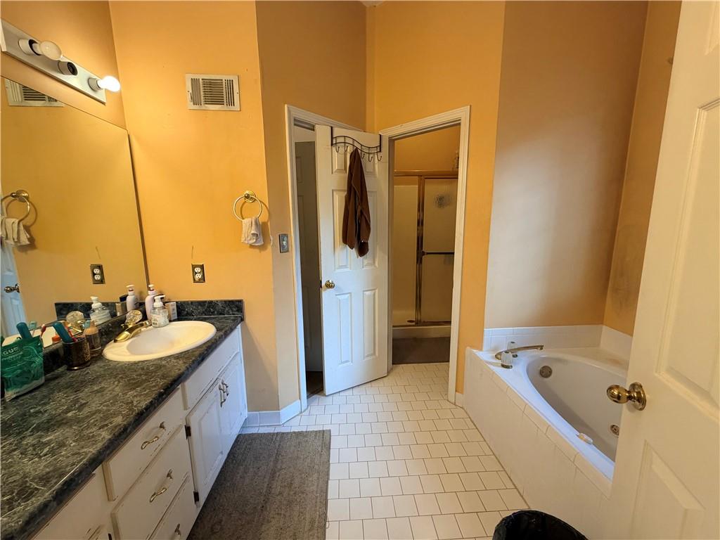 426 Pates Lake Court Hampton, GA 30228 - Photo 29 of 60 a spacious bathroom with a granite countertop tub sink and mirror