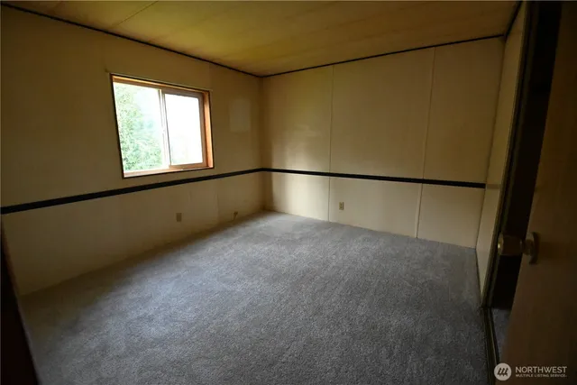 a view of an empty room with a window