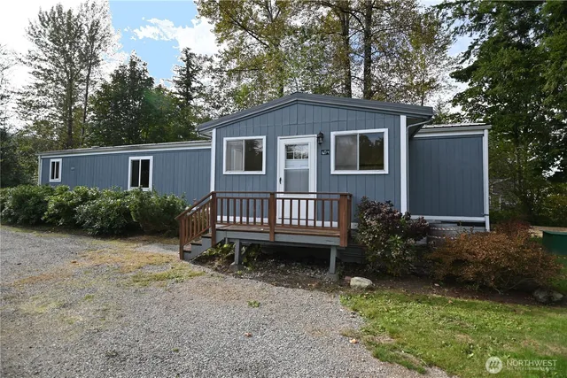 a view of a house with a yard and wooden fence