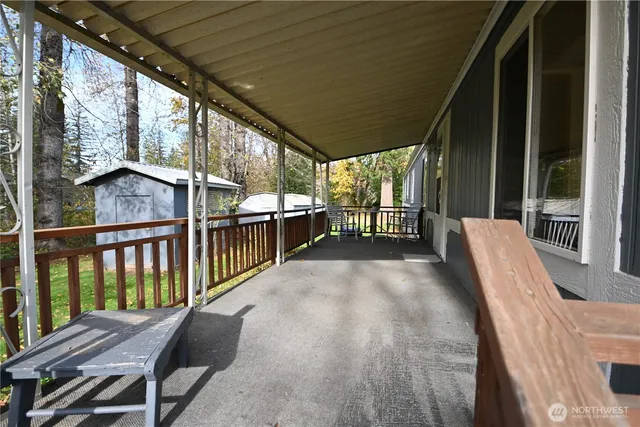 a view of balcony with wooden floor and outdoor seating