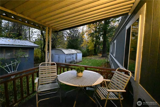 a view of balcony with a table and chairs