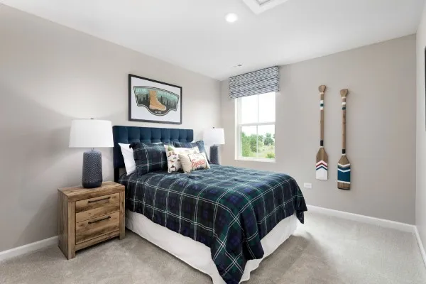 a bedroom with a bed and a painting on the wall