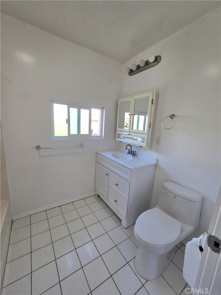 2303 Graydon Avenue Monrovia, CA 91016 - Photo 13 of 16 a bathroom with a toilet a sink a mirror and a window
