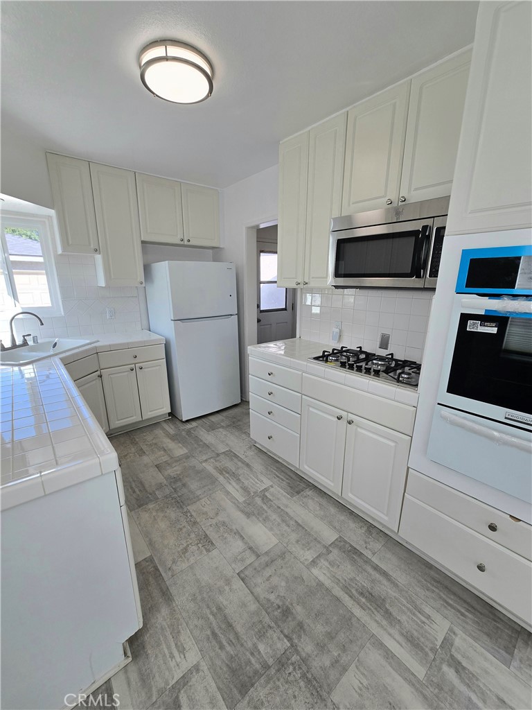 2303 Graydon Avenue Monrovia, CA 91016 - Photo 4 of 16 a kitchen with cabinets and white appliances