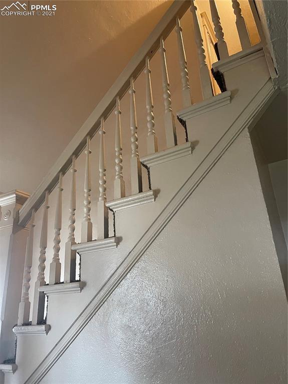 2210 East Routt Avenue Pueblo, CO 81004 - Photo 12 of 23 a view of staircase with railing and white walls
