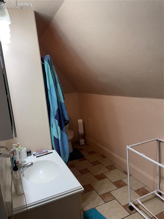 2210 East Routt Avenue Pueblo, CO 81004 - Photo 17 of 23 a bathroom with a sink and a mirror