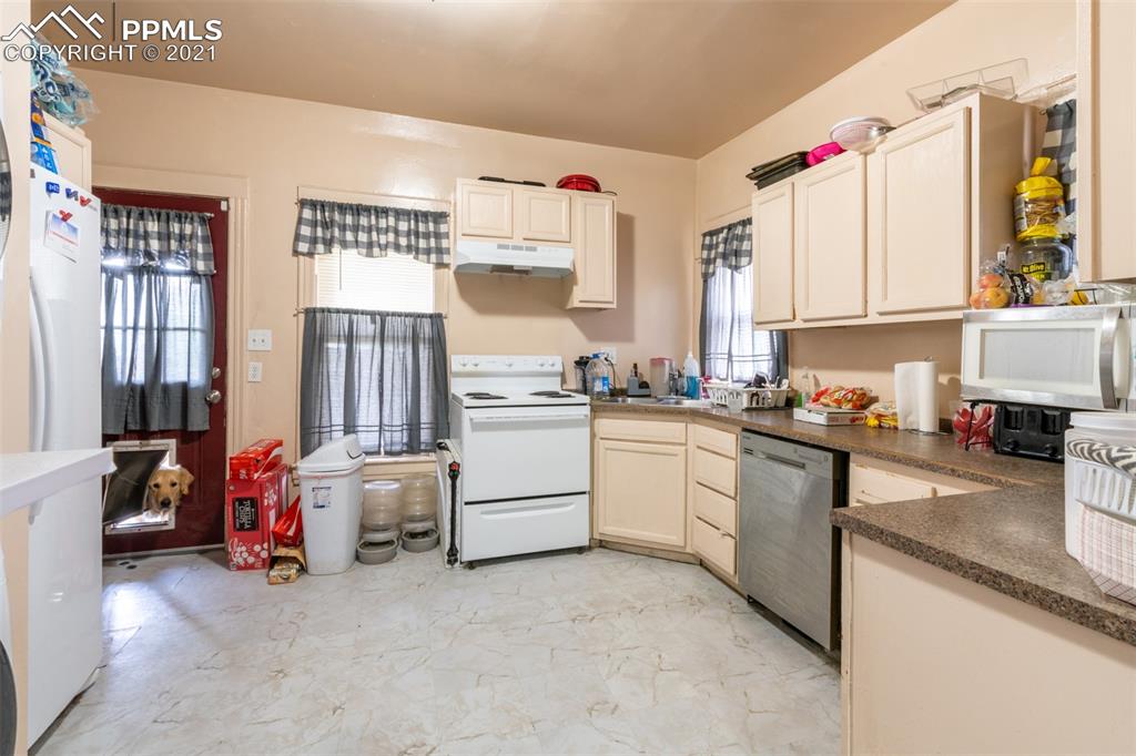 2210 East Routt Avenue Pueblo, CO 81004 - Photo 4 of 23 a kitchen that has a lot of cabinets in it and appliances